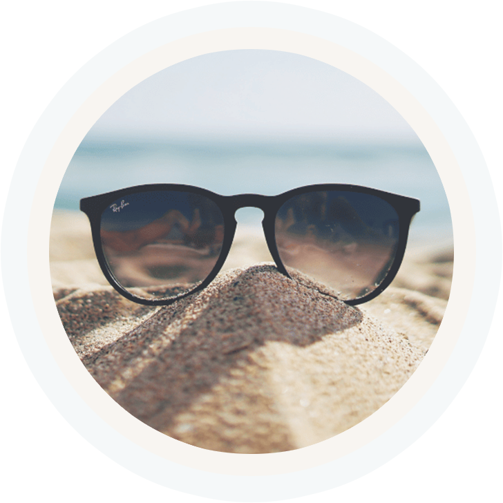 glasses in sand at beach